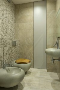 Home A contemporary bathroom featuring stone textures and modern fixtures.